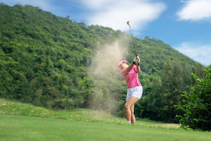 Golf women. Cheerful happy asian smiling woman with playing golf in the golf club in the sunny time, copy space. Lifestyle Concept