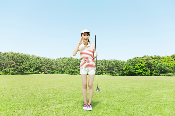 Japanese golfer standing on the golf course