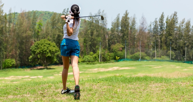 Golfer sport course golf ball fairway. People lifestyle woman playing game golf tee of on green grass. Asia female player game shot in summer. Healthy and Sport outdoor