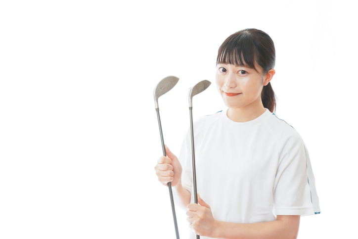 Young woman holding golf club