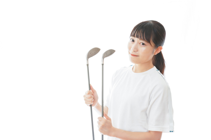 Young woman holding golf club