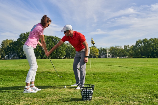 Beginner female golfer learning a proper golf grip